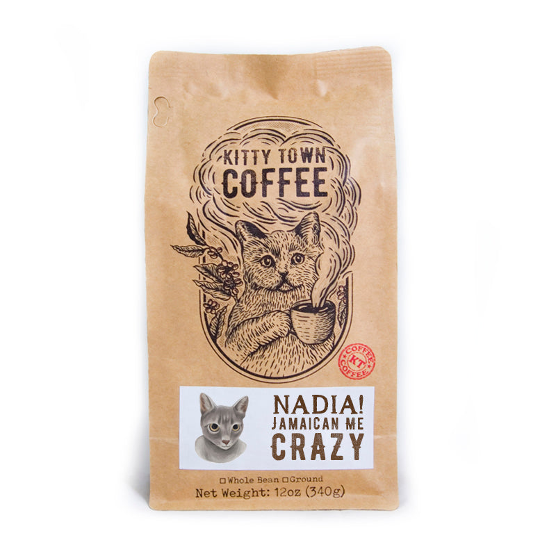 A bag of Nadia! Jamaican Me Crazy! coffee blend featuring hazelnut and caramel flavors, with a playful design representing the Kitty Town family.